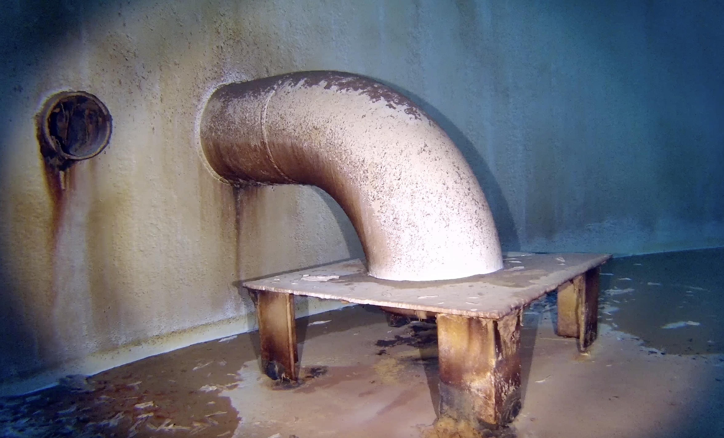 Sediment accumulation observed near internal piping.