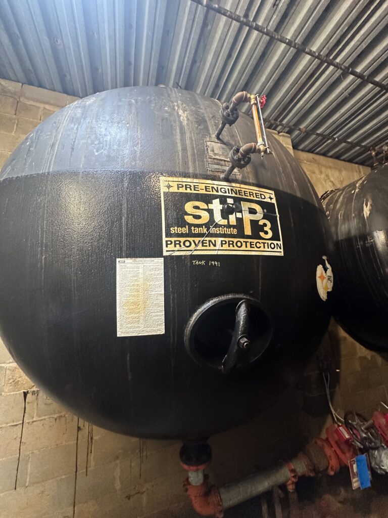 Fire protection pressure tank with access opening below waterline requiring drained internal inspection